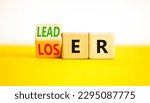 Small photo of Loser or leader symbol. Businessman turns wooden cubes and changes the word Loser to Leader. Beautiful yellow table white background. Business and loser or leader concept. Copy space.