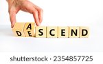 Small photo of Ascend or descend symbol. Concept words Ascend and Descend on wooden cubes. Beautiful white table white background. Businessman hand. Business ascend or descend concept. Copy space.