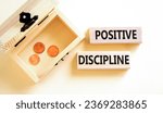 Small photo of Positive discipline symbol. Concept words Positive discipline on beautiful wooden blocks. Beautiful white background. Chest with coins. Business psychology positive discipline concept. Copy space.