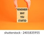 Small photo of Remember why you started symbol. Concept word Remember why you started on wooden block. Beautiful orange table background. Businessman hand. Business remember why you started concept. Copy space.
