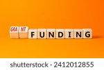 Small photo of Grant funding symbol. Concept words Grant funding on beautiful wooden blocks. Beautiful orange table orange background. Business and grant funding concept. Copy space.