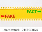 Small photo of Fact or fake symbol. Concept word Fake and Fact on beautiful yellow paper. Beautiful white paper background. Business and fact or fake concept. Copy space.
