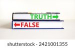 Small photo of Truth or false symbol. Concept word Truth or False on beautiful books. Beautiful white table white background. Business and truth or false concept. Copy space.