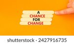 Small photo of A chance for change symbol. Concept words A chance for change on wooden stick. Beautiful orange table orange background. Voter hand. Business A chance for change concept. Copy space.