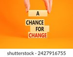 Small photo of A chance for change symbol. Concept words A chance for change on beautiful wooden block. Beautiful orange table orange background. Voter hand. Business A chance for change concept. Copy space.