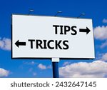 Small photo of Tips and tricks symbol. Concept word Tips and tricks on beautiful billboard with two arrows. Beautiful blue sky with clouds background. Business and Tips and tricks concept. Copy space.