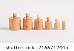 Small photo of Hierarchy concept. Row of Montessori knobbed cylinders from bigger to smaller. Kids toy for development of dimension perception. Ordering, ranking. High quality photo