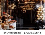 decor to the 35th anniversary. black wall with a gold inscription happy birthday 35 and with black and gold balloons, candy bar. birthday party.
