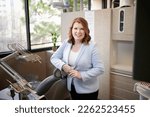 THE WOODLANDS, TEXAS - FEBRUARY 2023: a dental surgeon is posing for environmental business portraits in her practice. She specializes in Laser Dentistry, DURAthin, Lumineer veneers, dental implants.