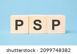 Small photo of psp word written on wooden cubes with copy space