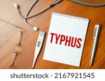Small photo of sheet of paper with the text typhus and stethoscope. Medical concept