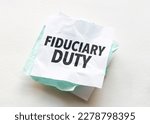 Small photo of paper with text fiduciary duty on white background