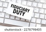 Small photo of fiduciary duty written on paper sheet on a computer keyboard