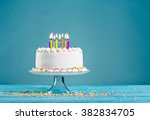 White birthday cake over blue background