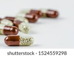 Small photo of capsules, pills, enzymes, medicine. Health. White background