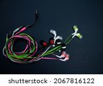 Small photo of headphones, wired headphones, wire, colored wires, black background, pink wire, gray wire, green wire, accessories.