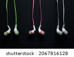 Small photo of headphones, wired headphones, wire, colored wires, black background, pink wire, gray wire, green wire, accessories.