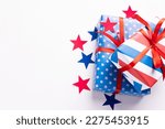 4th of July American Independence Day. Happy Independence Day. Red, blue and white star confetti, paper decorations on white background. Flat lay, top view, copy space, banner. High quality photo