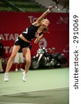 Small photo of Meghann Shaughnessy serving in the doubles vs Kirilenko/Hingis at Qatar Total Open, March 2, 2007.