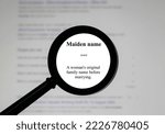Small photo of Selective focus on word Maiden name, word in a dictionary. Close up of an English dictionary page with word maiden name.