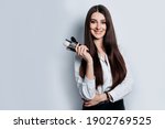 Makeup artist with brushes in hand on a white background