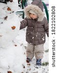  Little Girl Making A Snowman