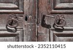 Small photo of Swiss Landscape: Soglio. A small tiny hamlet in Grisons canton. Handcrafted metal door gracefully engraved knockers, on wooden door.