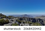 Small photo of At the top of Table Mountain in Cape Town there is scant vegetation, gray boulders. Clear blue sky. A sunny summer day. South Africa