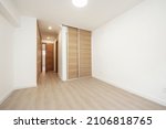 Small photo of Bedroom with fitted wardrobes with sliding doors and normal doors in light oak wood and floors of the same material