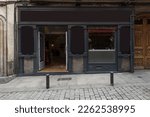 Small photo of facade a commercial premises of an old building with wood in the showcase