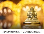 Small photo of Selective focus on statue of Lord Ganesha, Ganesha Festival. Hindu religion and Indian celebration of Diwali festival concept on dark, red, yellow background. Festival and religious concept