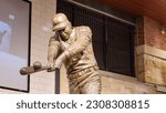 Small photo of Atlanta, Georgia USA - 5 24 2023: A statue of the baseball player Hank Aaron hitting a baseball inside of at Truist Park in Atlanta Georgia USA