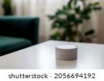 Small photo of Smart home speaker device voice activate at white table. Wireless speaker, voice controlled smart speaker and personal assistant at home, technologies