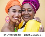 Portrait of happy african mother and daughter face to face while hug each other - Family, mother and adult child love - Women with traditional dress
