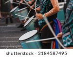 Small photo of Music band playing drums in the street at public event. Drummers musicians playing music at Pride festival in June. Pride month march celebration. Queer lgbt community awareness.