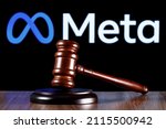 Small photo of Kazan, Russia - Jan 31, 2022: Gavel on table against the background of Meta company logo. The concept of the trial.