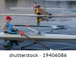 three rowers competing.