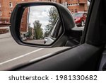 Car Road Trip Concept. Car Driving Conceptual Photo. Outside Mirror. Objects in mirror are closer than they appear  with Blind Spot Assist Warning LED Sensor Light