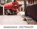 Sewage Tank truck. Sewer pumping machine. Septic truck. Pipe in the drainage pit. Pumping out sewage from a septic tank. Septic tank service