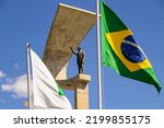 Small photo of BRASILIA DF BRAZIL - JULY 23 2022: Detail of the monument and flags in front of the JK Memorial, architectural project by Oscar Niemeyer.