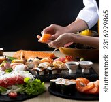 Small photo of Sushi of japanese, Chef hands preparing japanese food, japanese chef making sushi at restaurant