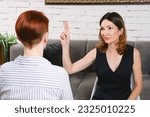 Small photo of Attractive woman is having a wing wave session with a client. Certified coach uses an integrative neuropsychological method aimed at working with destructive emotional states