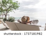 Relaxation holiday vacation of businessman take it easy happily resting on beach chair at swimming pool poolside beachfront resort hotel with sea or ocean view and summer sunny sky outdoor