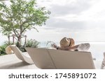 Small photo of Relaxation holiday vacation of businessman take it easy happily resting on beach chair at swimming pool poolside beachfront resort hotel with sea or ocean view and summer sunny sky outdoor