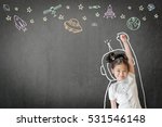 Kid's learning inspiration world in science education with girl child's imagination doodle on teacher's school chalkboard for back to school month and international or universal children's day concept