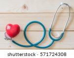 Small photo of World health day campaign with red love heart with cross bandage (band-aid) and medical doctor's stethoscope, first aid concept