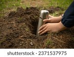 Bury a time capsule in the ground.Leave a message for the future in the ground.Hide a treasure with a child in the forest.