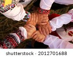 The hands of children in embroidered shirts are intertwined in a welcoming gesture. The united hands symbolize unity. Independence Day of Ukraine, Constitution, Embroidery