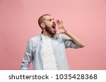 Do not miss. Young casual man shouting. Shout. Crying emotional man screaming on pink studio background. male half-length portrait. Human emotions, facial expression concept. Trendy colors
