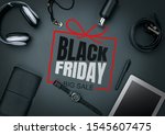 Top view of gadgets with black friday lettering on black background. Copyspace for your ad. Black friday, sales, finance, advertising, money, finance, purchases concept. Headphone, watch, tablet.
